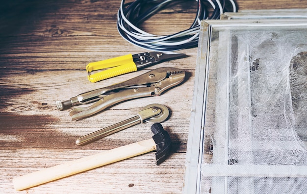 hand-tools-set-damaged-mosquito-wire-screen-which-need-be-fixed_1150-6573