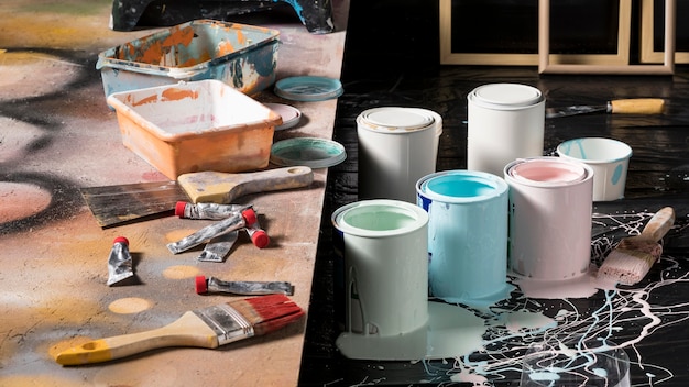 high-angle-colored-paint-cans-studio_23-2148591280